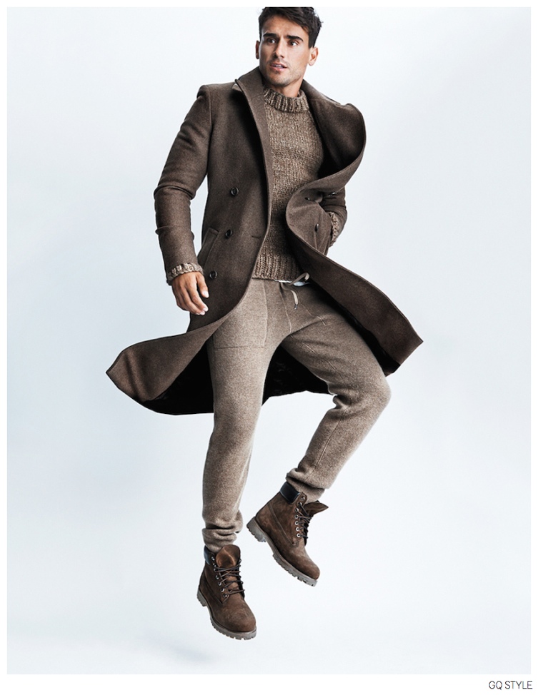 Premium Photo | A male model of black ethnicity in a fashion pose on a  brown metallic background with his foot propped up