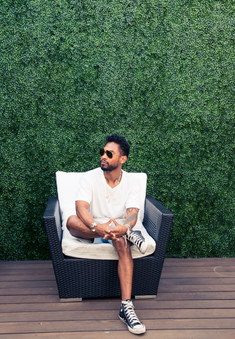 Miguel pictured outside in denim cut-offs.