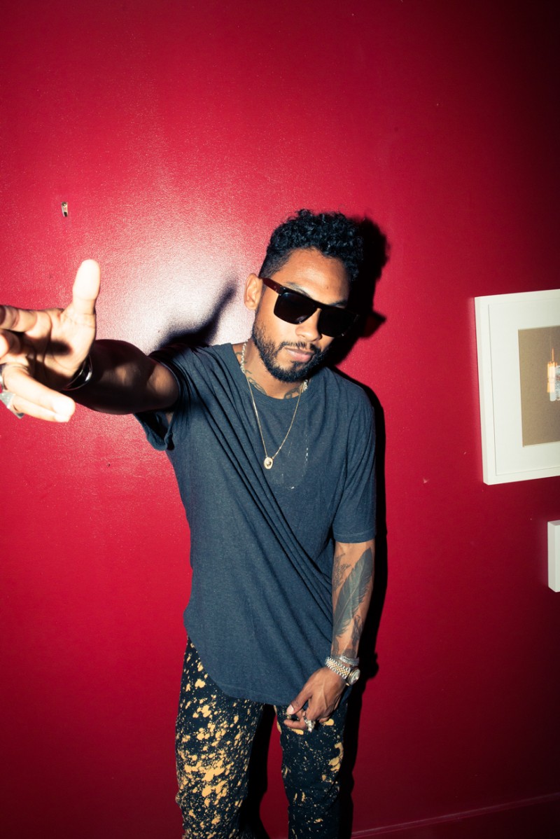 Miguel wears a simple tee with splatter print denim jeans.