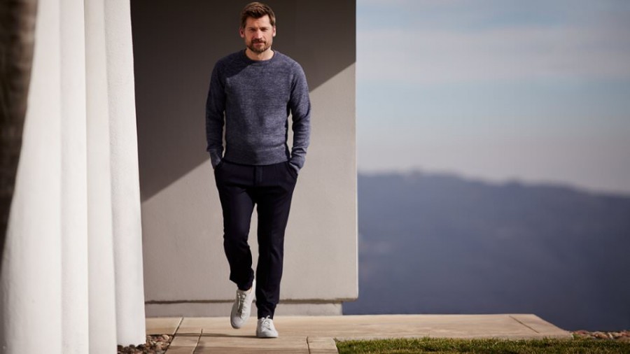 Nikolaj Coster-Waldau wears sweatshirt Tom Ford, trousers Berluti and sneakers Common Projects.