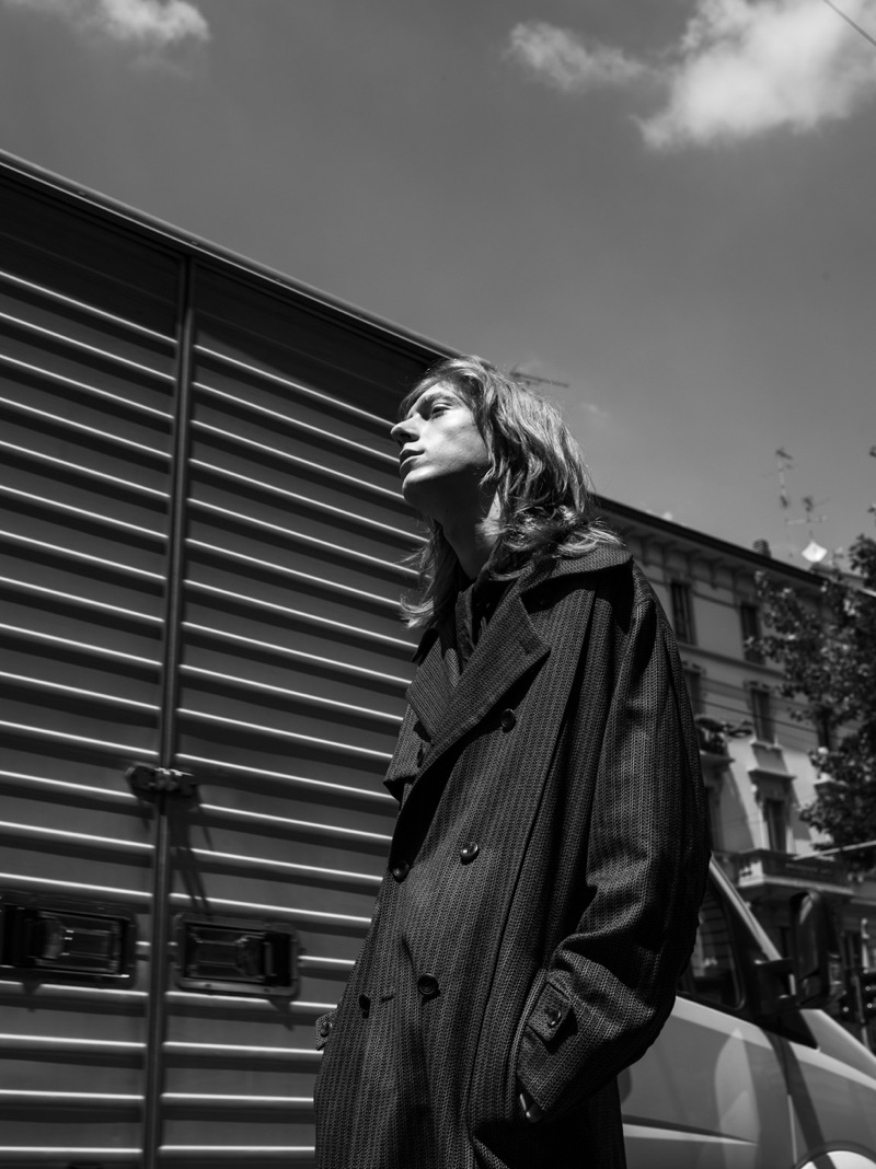 Simone Battistoni photographs Mattia Pardini in a trench coat, sweater, and scarf from Corneliani. 