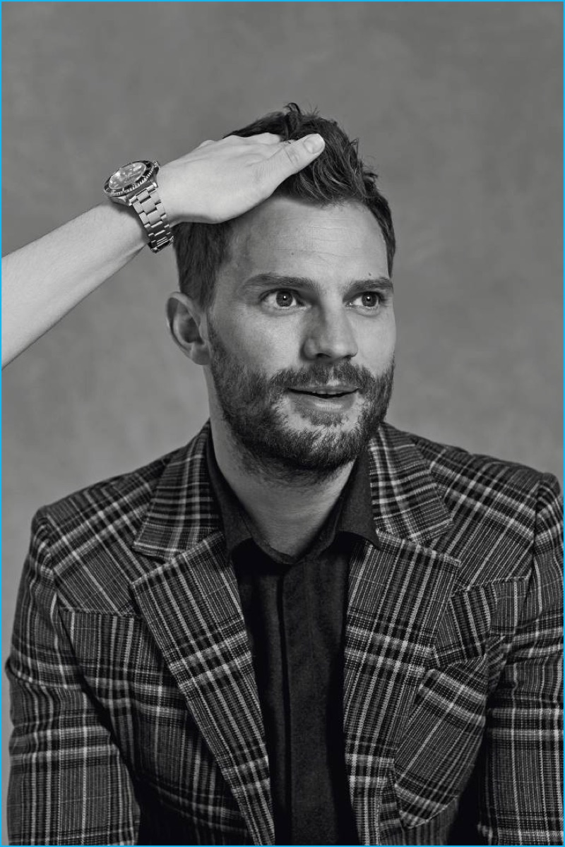 Appearing in a photo shoot for Icon El País, Jamie Dornan dons a check Prada jacket with an Emporio Armani shirt.