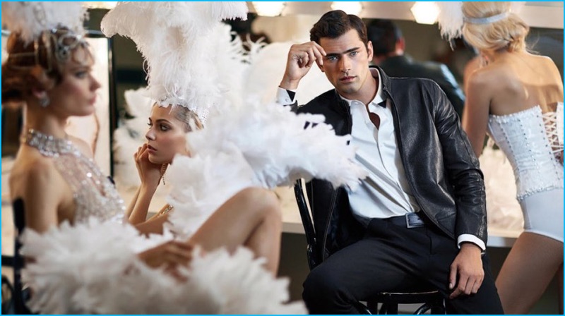 Wearing a leather jacket, Sean O'Pry poses with showgirls for Vicutu's fall-winter 2016 campaign.