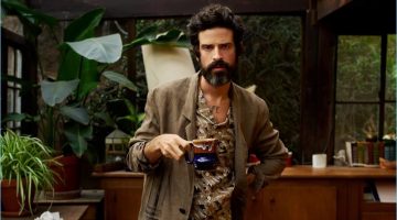 Embracing the style of an artist, Devendra Banhart sports a Valentino camp-collar shirt with trousers and a painted linen overcoat by Isabel Benenato.