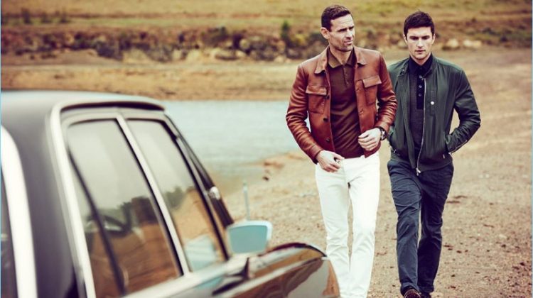 Left: Cornelius wears a brown Prada leather jacket and virgin wool polo shirt. Dan May also styles Cornelius in Dolce & Gabbana white denim jeans with Saint Laurent sneakers. Right: Charlie Timms sports a Brunello Cucinelli leather bomber jacket and cotton twill trousers. The English model also dons a Tom Ford polo shirt and Burberry sneakers.