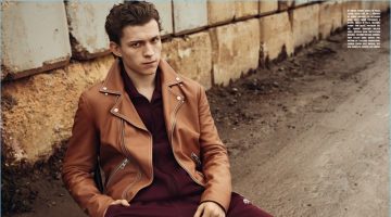 Appearing in a photo shoot for L'Uomo Vogue, Tom Holland wears a brown Loewe leather jacket with a jumpsuit from Adidas Originals by Alexander Wang.