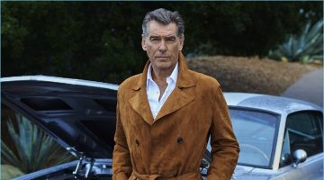 Pierce Brosnan dons a shirt and suede trench coat by Ermenegildo Zegna with AG jeans, and Vince Camuto boots.