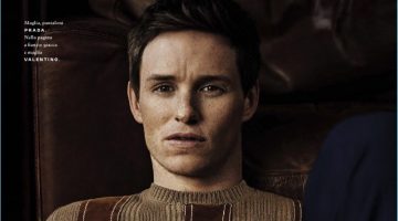 Front and center, Eddie Redmayne sports a sweater and trousers by Prada.