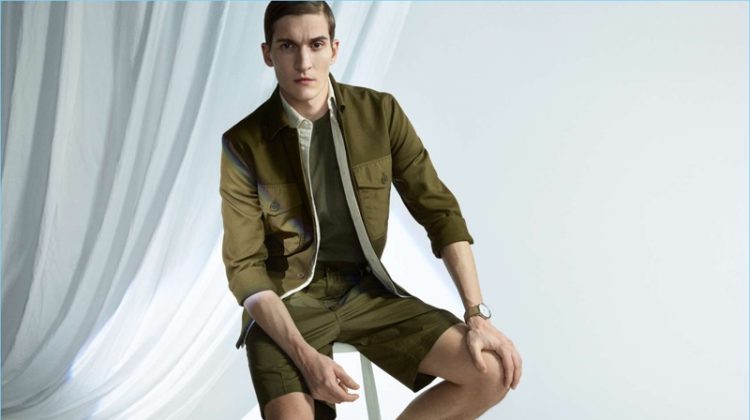 H&M champions the military trend with green fashions. Matvey Lykov wears a utility jacket with a pima cotton shirt and chino shorts.