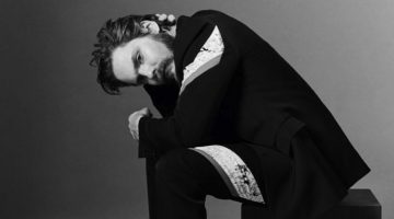 Appearing in a photo shoot for Crash magazine, Daniel Brühl sports a Dior Homme shirt and suit with Nike sneakers.