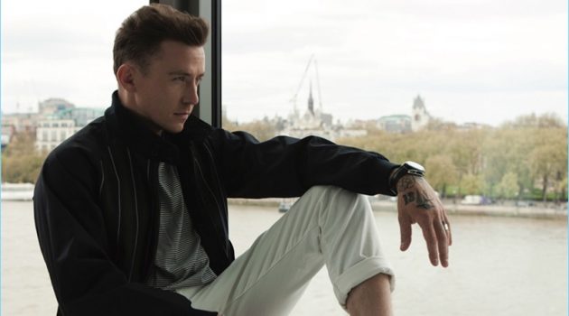 Taking in a quiet moment, Danny Jones wears an Aquascutum t-shirt, Grenfell jacket, Scotch & Soda jeans, and Oliver Sweeney sneakers.