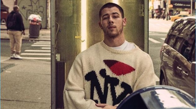 Venturing outdoors, Nick Jonas wears a Raf Simons NY sweater.