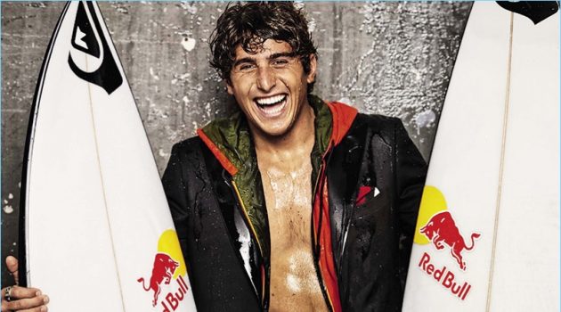 All smiles, Leonardo Fioravanti wears a Tagliatore blazer with a hooded K-Way jacket, and Quiksilver wetsuit.