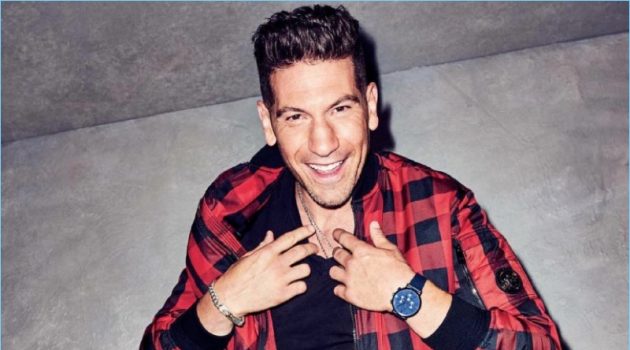 All smiles, Jon Bernthal wears a buffalo check jacket and leather pants by Versace. Bernthal also dons an Armani Exchange t-shirt and Saturdays NYC sneakers.