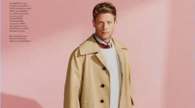 Front and center, James Norton wears a Burberry sweatshirt and coat. The actor also dons a Kent & Curwen tie, Salvatore Ferragamo trousers, and AMI derby shoes.