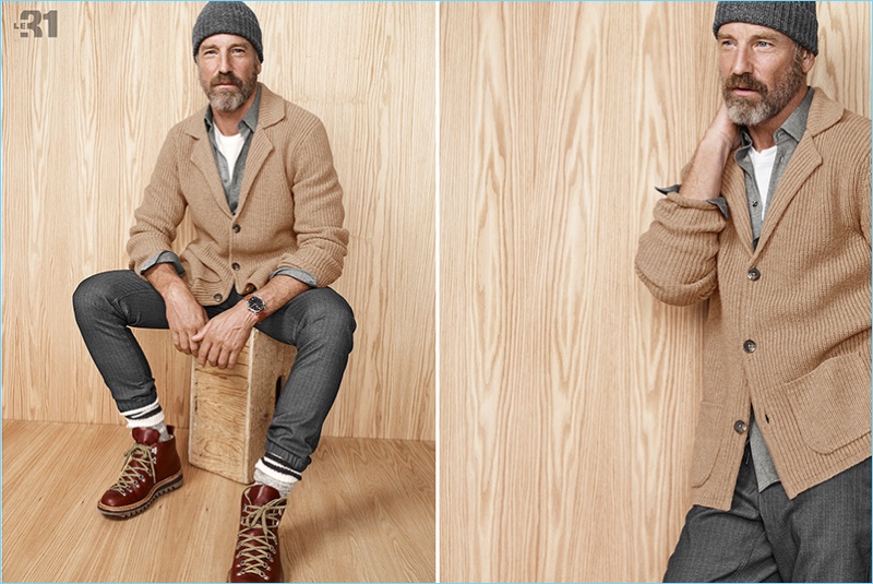 A rugged vision, Rainer Andreesen sports a camel colored cardigan with a knit beanie and hiking boots.