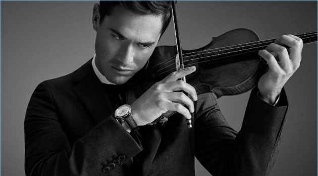 Playing the violin, Charlie Siem wears a Prada wool suit and sweater. He also sports a Jil Sander shirt and Jaeger-LeCoultre watch.