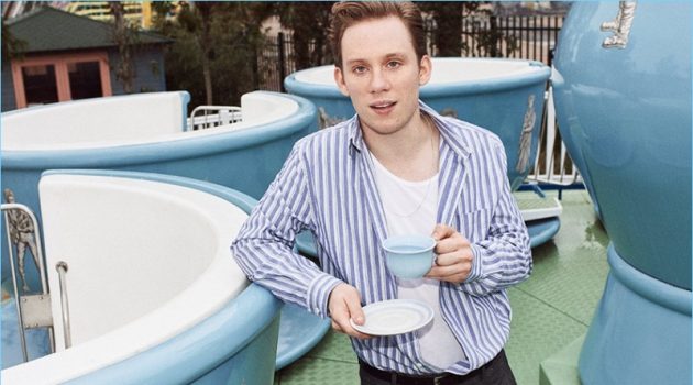 Enjoying a cup of tea, Joe Cole wears an Acne Studios striped oxford shirt and Sunspel tank. He also sports Maison Margiela checked trousers and a Lanvin leather belt.