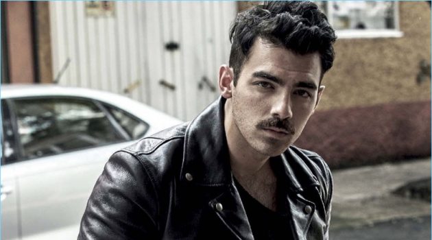 A cool vision, Joe Jonas rocks a Salvatore Ferragamo leather jacket. The singer also dons a sweater and pants by GUESS.