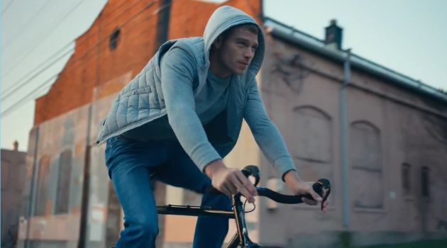 American model Matthew Noszka rides a bike in Express' Tough denim jeans.