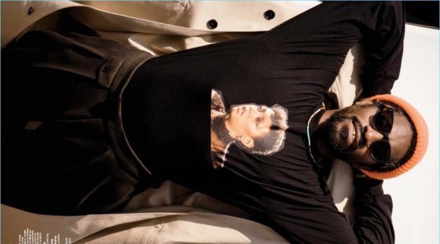 Appearing in a shoot for GQ Style, André 3000 Benjmain wears a BOSS coat and pants with a custom t-shirt.