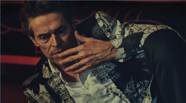 Connecting with Essential Homme, Willem Dafoe sports a dapper look from Alexander McQueen.