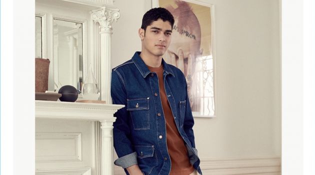 Sporting a classic look, Torin Verdone wears an AMI denim worker jacket with A.P.C. chinos. The model also dons a Theory tee and Converse sneakers.