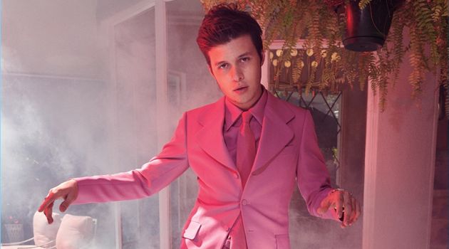 Showcasing his best dance moves, Nick Robinson wears a pink Gucci suit, shirt, and tie.