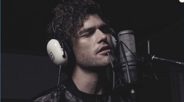 Taking to the studio, Vance Joy wears a bomber and tee by Emporio Armani.