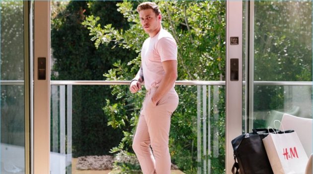 Gus Kenworthy makes a statement in pink. He wears a H&M round-necked t-shirt and chinos.