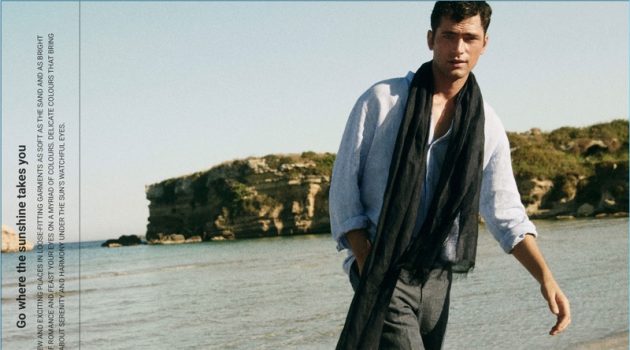 Connecting with Massimo Dutti, Sean O'Pry wears a linen band collar shirt. He also dons a linen scarf and chinos.