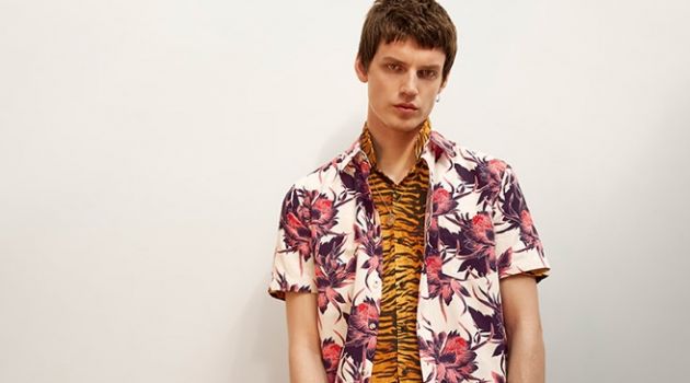 Layering for a bold effect, Theo Neilson wears a floral printed short-sleeve shirt with a tiger print shirt from Topman.