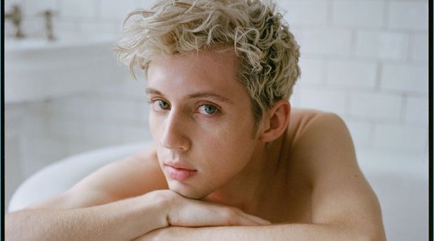 Posing in a bathtub, Troye Sivan rests on a Stella McCartney sweater.