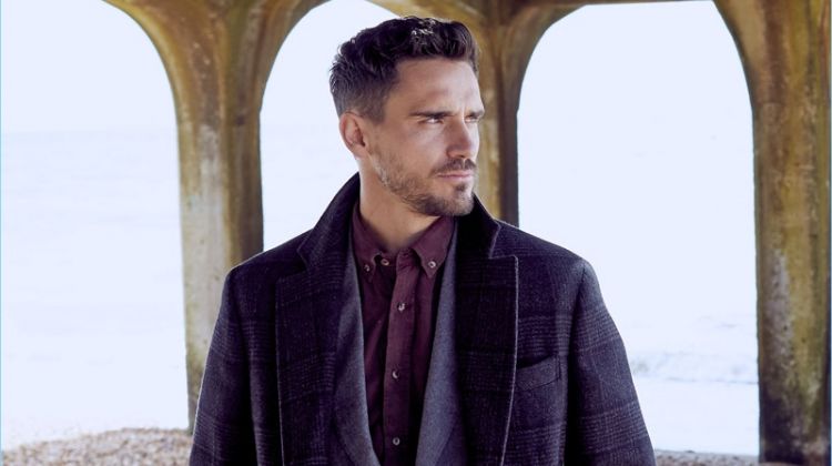A sleek vision, Arthur Kulkov dons a Brunello Cucinelli suit, overcoat, and shirt.