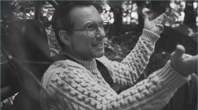 A smart vision, Christian Slater dons a Brioni cable-knit sweater and Gucci glasses.