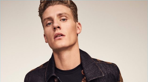 Front and center, Mikkel Jensen rocks an embroidered denim jacket and t-shirt with jeans from River Island's RI30 collection.