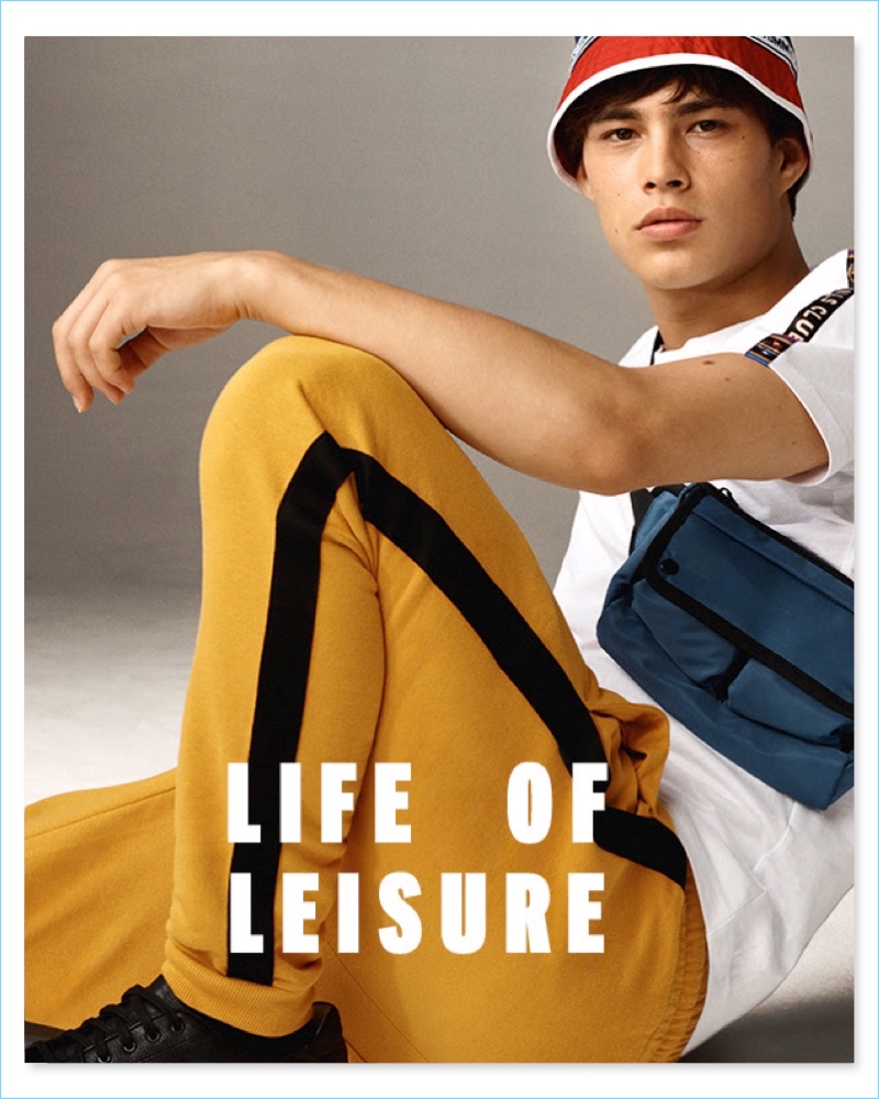 Life of Leisure: Louis Baines models Topman yellow and black side stripe joggers with black lace sneakers.