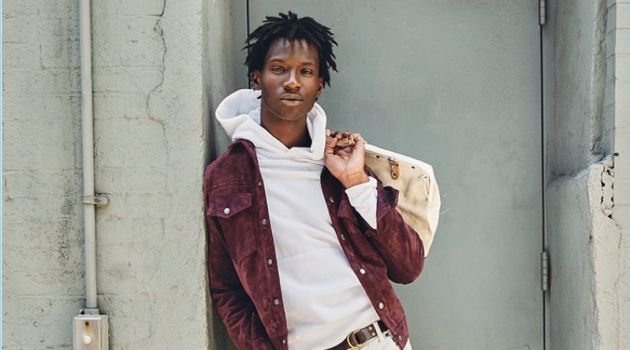 A chic vision, Adonis Bosso wears a Todd Snyder suede jacket and 5-pocket white pants with a Todd Snyder + Champion hoodie.