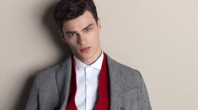 Model Filip Hrivnak wears a red cardigan with a grey suit for Gazzarrini's fall-winter 2018 campaign.