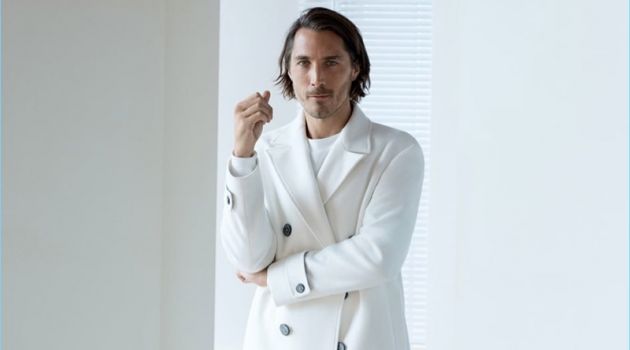 Sporting winter white, Guillaume Macé appears in an editorial for Zara.