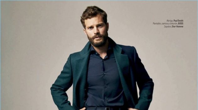 Embracing fall style, Jamie Dornan wears a Paul Smith coat with a shirt, belt, and pants by BOSS. Dior Men shoes complete his look.