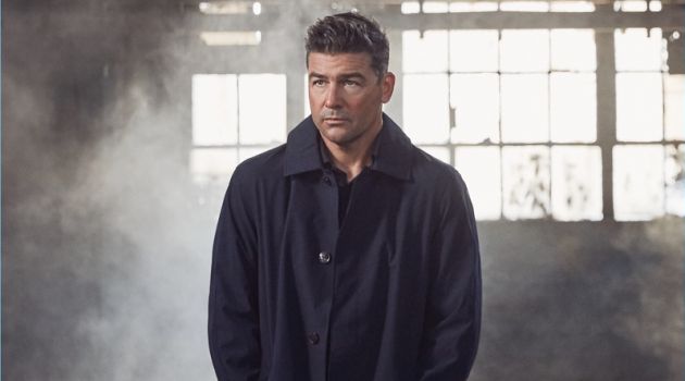 Starring in a photo shoot, Kyle Chandler wears a Michael Kors coat with a shirt nd trousers by Ermenegildo Zegna.