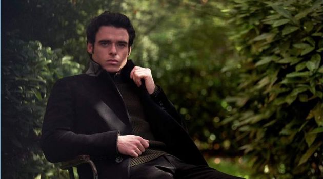 Venturing outdoors, Richard Madden sports a Burberry coat, Mr P. sweater, and Acne Studios jeans.