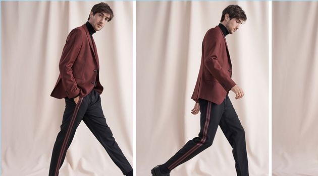 Hamilton Seguin wears a burgundy wool flannel blazer, varsity tape pants, and a coverlock turtleneck from Club Monaco. He also dons Wings + Horns Officer shoes.