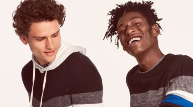 Models Simon Nessman and Shenai Gist sport color blocked sweaters from Express.