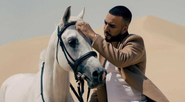 Enjoying a GQ moment, French Montana dons a Theory coat, Calvin Klein tank, Off-White track pants, and Fendi sliders.