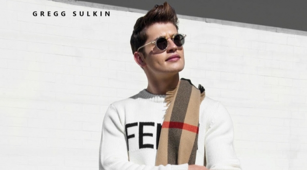 Stepping out, Gregg Sulkin wears a Fendi sweater, Burberry scarf, and G-Star Raw houndstooth pants.