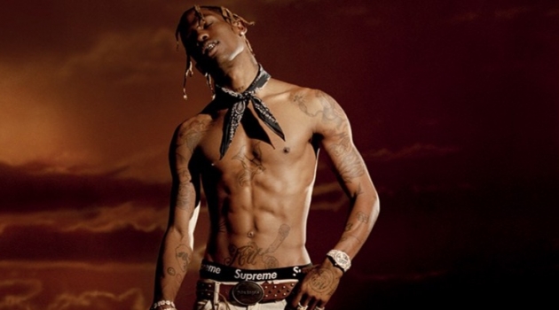 Posing for a new photo shoot, Travis Scott goes shirtless in a Palm Angels belt and trousers with an Alexander Wang bandana.