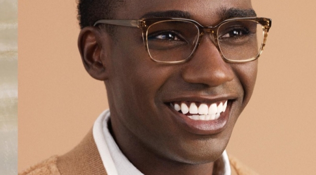 All smiles, Bakay Diaby dons Warby Parker's Hughes glasses in Chestnut Crystal.