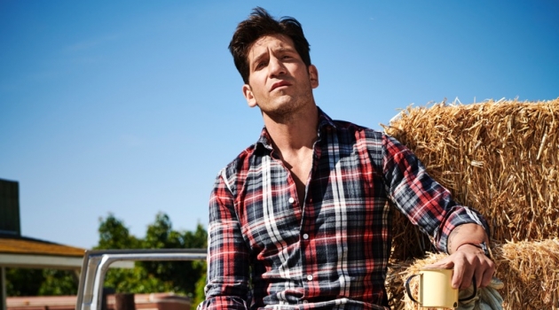 Embracing rugged style, Jon Bernthal wears an Eleventy shirt, Dolce & Gabbana jeans, Allen Edmonds boots, and a Movado watch.